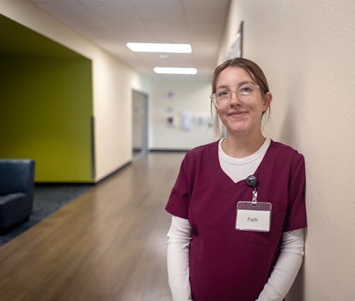student in maroon scrubs