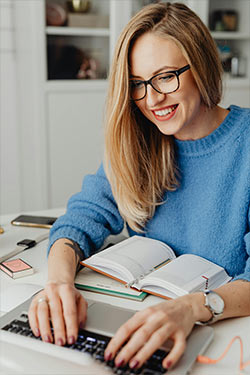woman wearing glasses sitting with a document